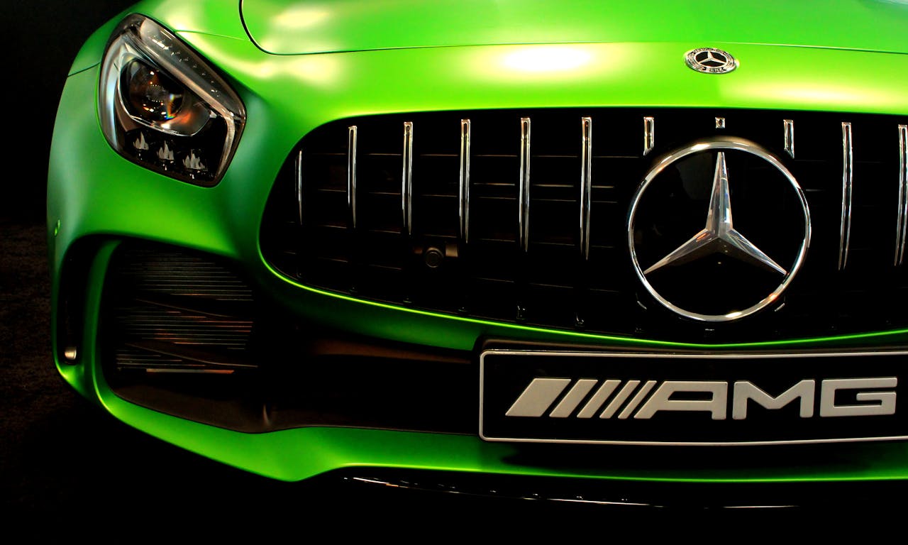 Close-up of a vibrant green Mercedes AMG grille showcasing the sleek design.